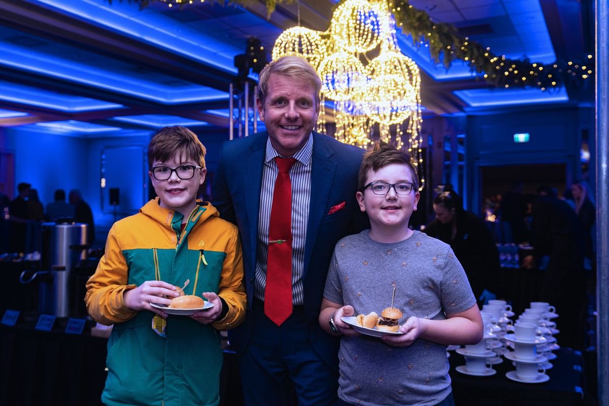 Host with young guests at a gala